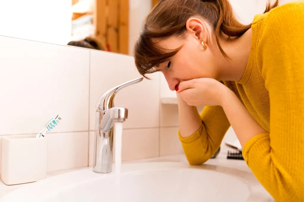 nauseous woman vomiting over sink Hand Sanitizer Germs