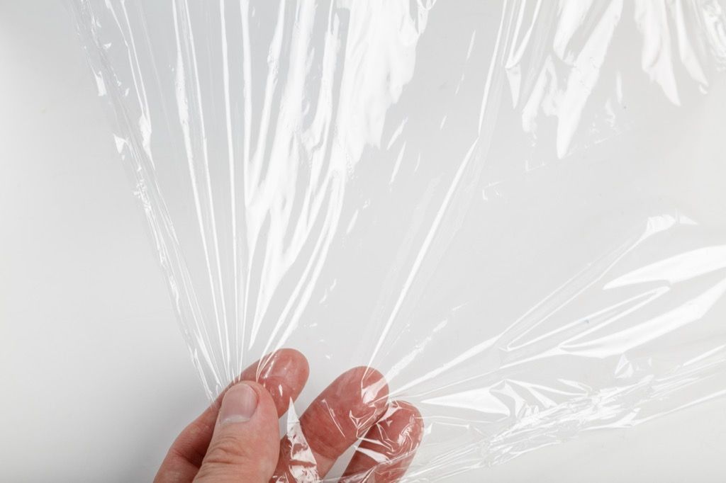 Hand pulling plastic wrap