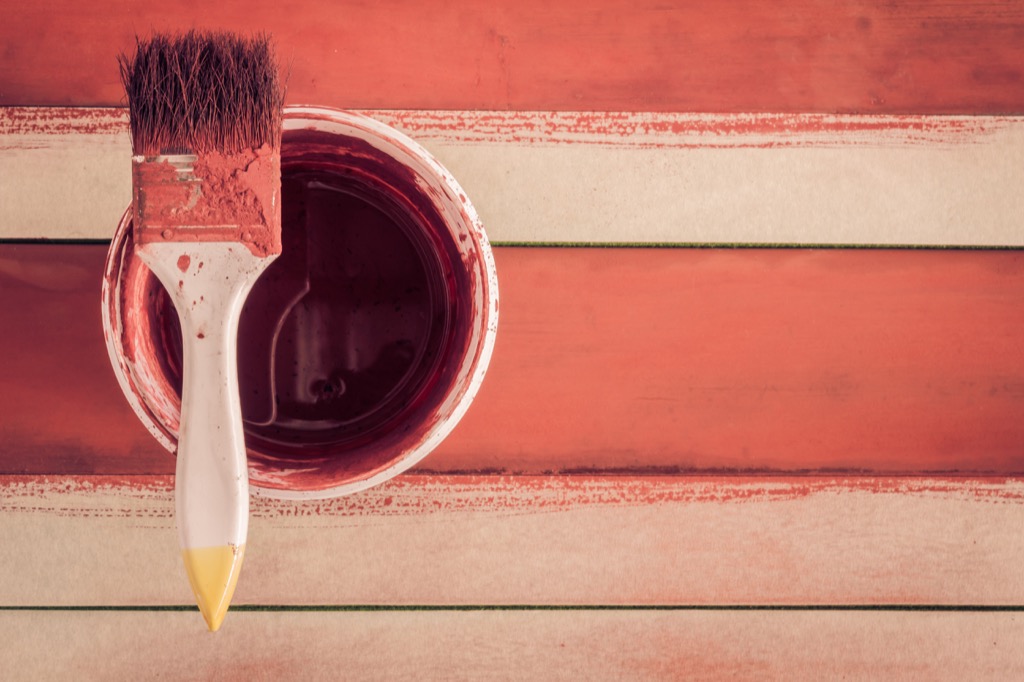 red paint bucket and brush