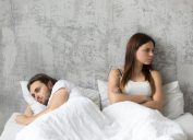 couple sitting in bed upset, stopped having sex