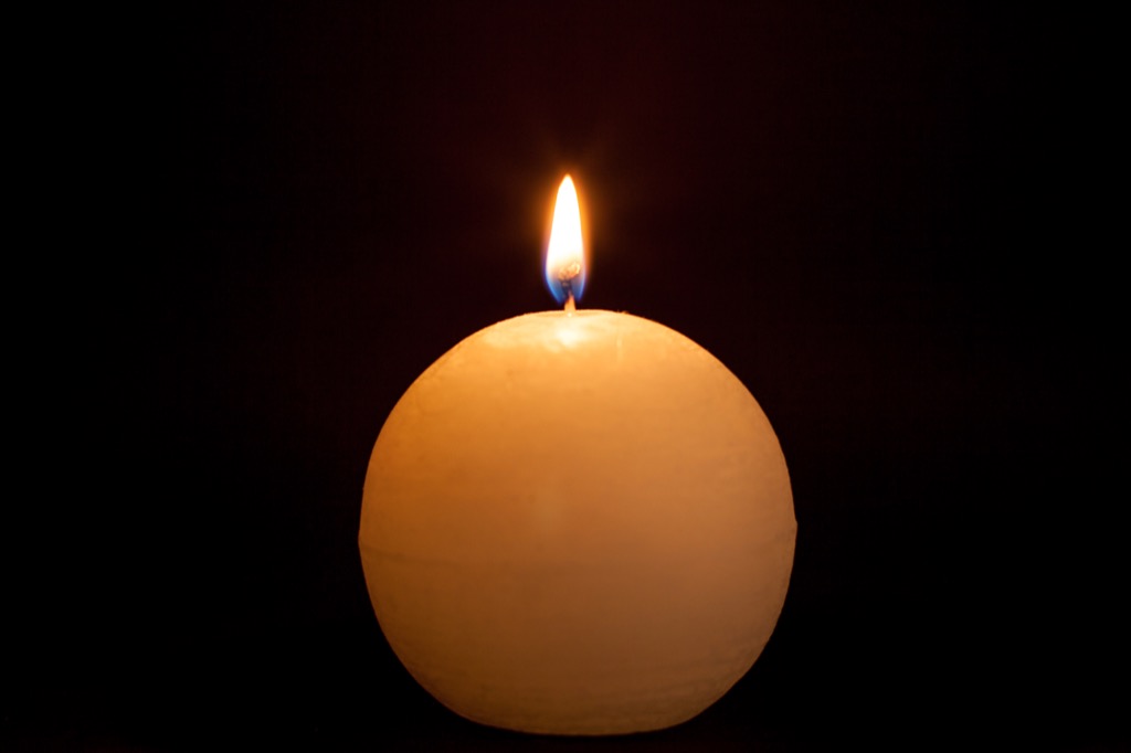 Round lit candle