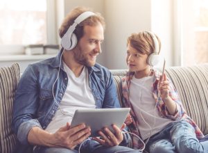 father and son listen to music together