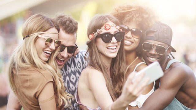 young people take selfies at coachella