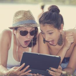 women looking shocked at ipad