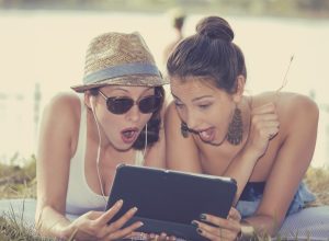 women looking shocked at ipad