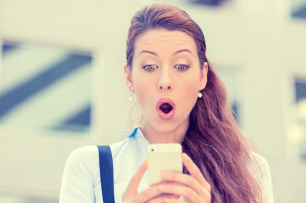 woman looking surprised at phone commonly misused phrases