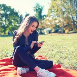 woman with smartphone in park