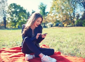 woman with smartphone in park