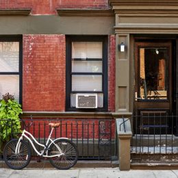 a bike bicycle and air conditioning unit outside a greenwich village new york city home