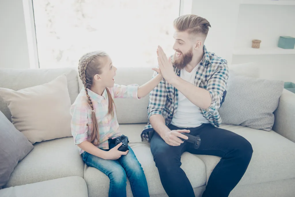 Dad Giving Daughter High Five Worst Things to Say to Kids
