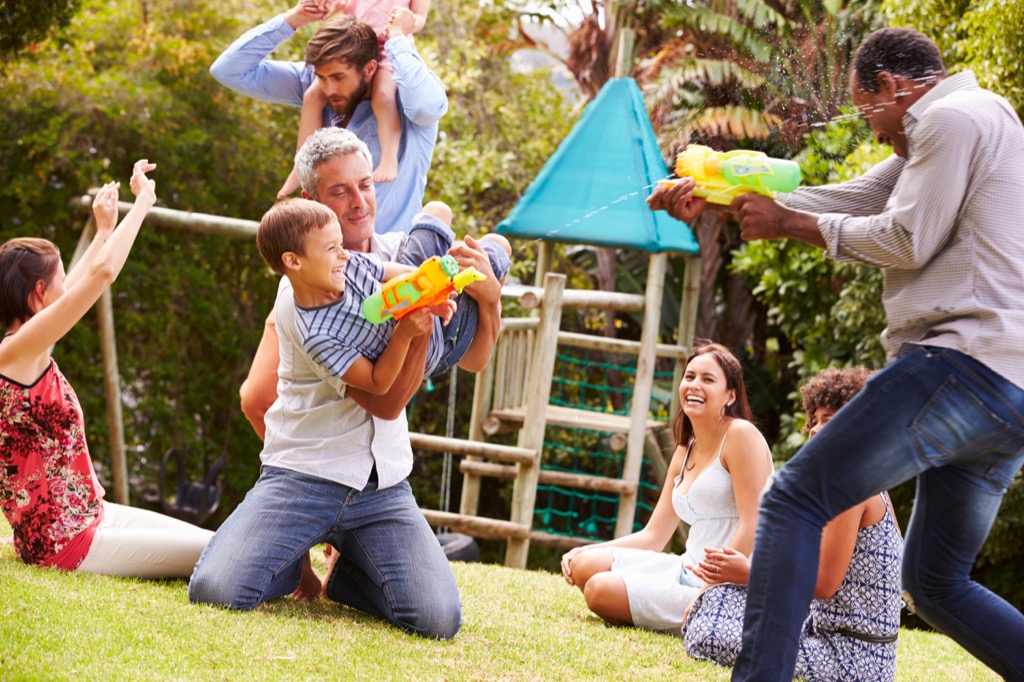 families playing with waterguns at park 20 surprising ways fatherhood changes you