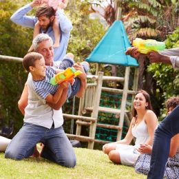 families playing with waterguns at park 20 surprising ways fatherhood changes you