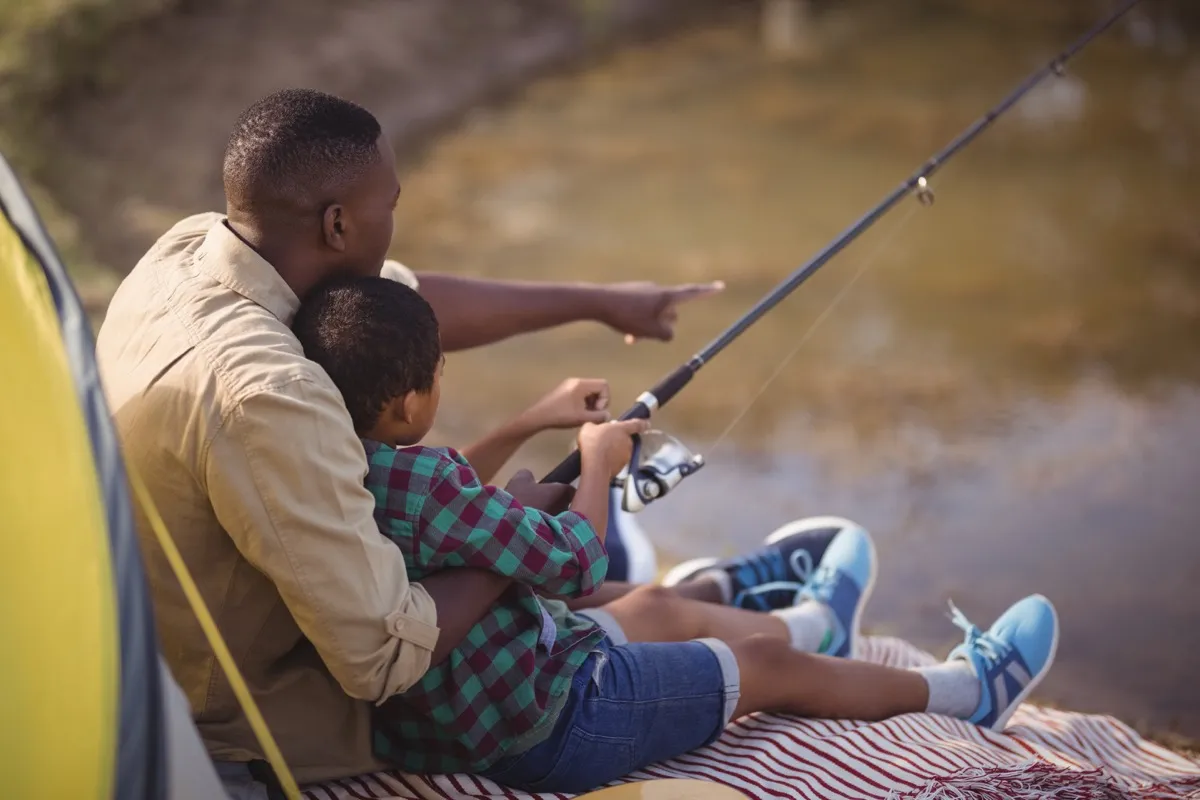 black father and son fishing
