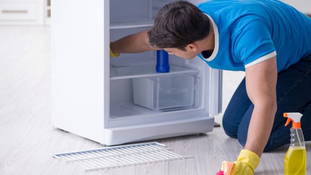 https://bestlifeonline.com/wp-content/uploads/sites/3/2018/06/man-cleaning-fridge.jpg?quality=82&strip=1&resize=640%2C360
