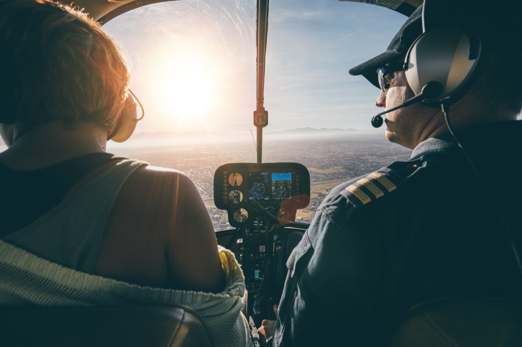 two pilots in the cockpit during sunset