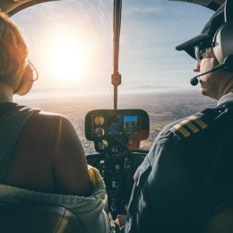 two pilots in the cockpit during sunset