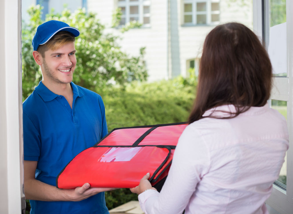Man delivering a pizza things burglars know about your home