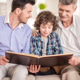 dad son and grandfather reading book