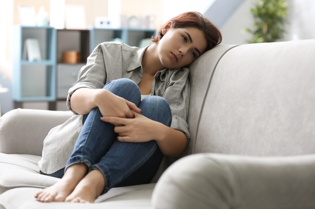 woman sad alone on couch