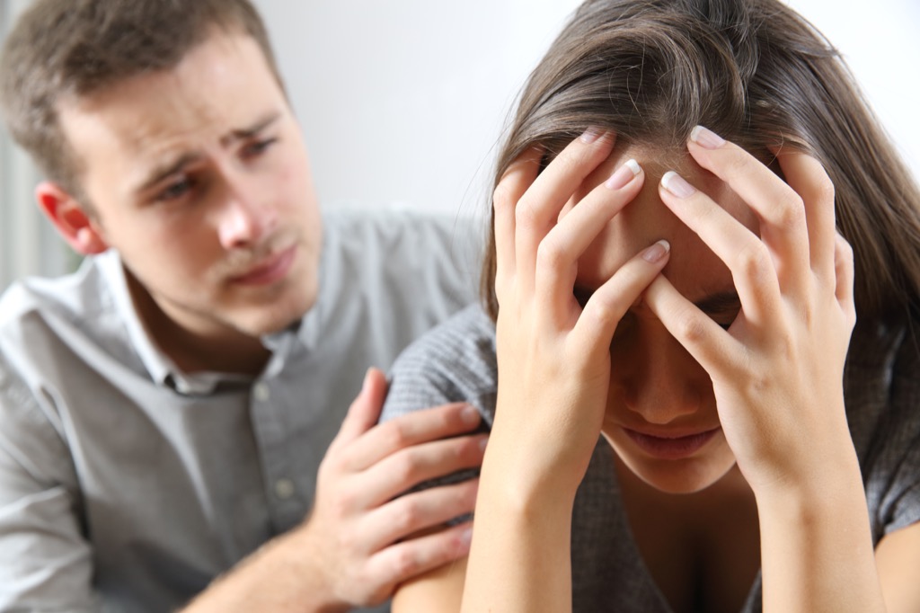 man comforts frustrated woman