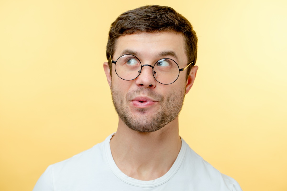 man whistling with a yellow background