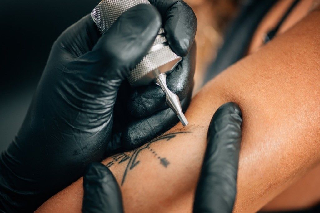 a woman getting first-time tattoos, bad parenting