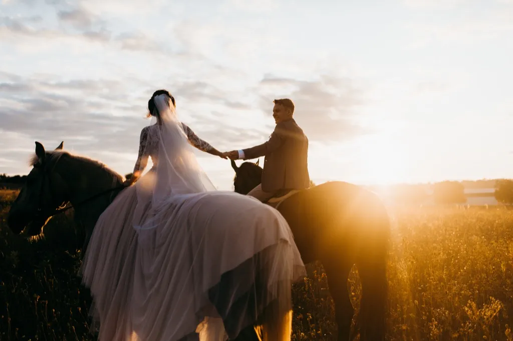 bride and groom on horseback This Is the Age Most People Get Married in Every U.S. State