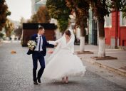 bride and groom walking on a street