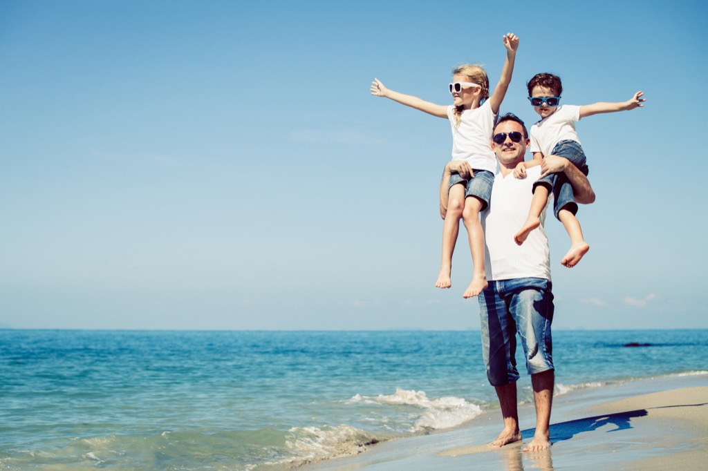 father with son and daughter on a beach