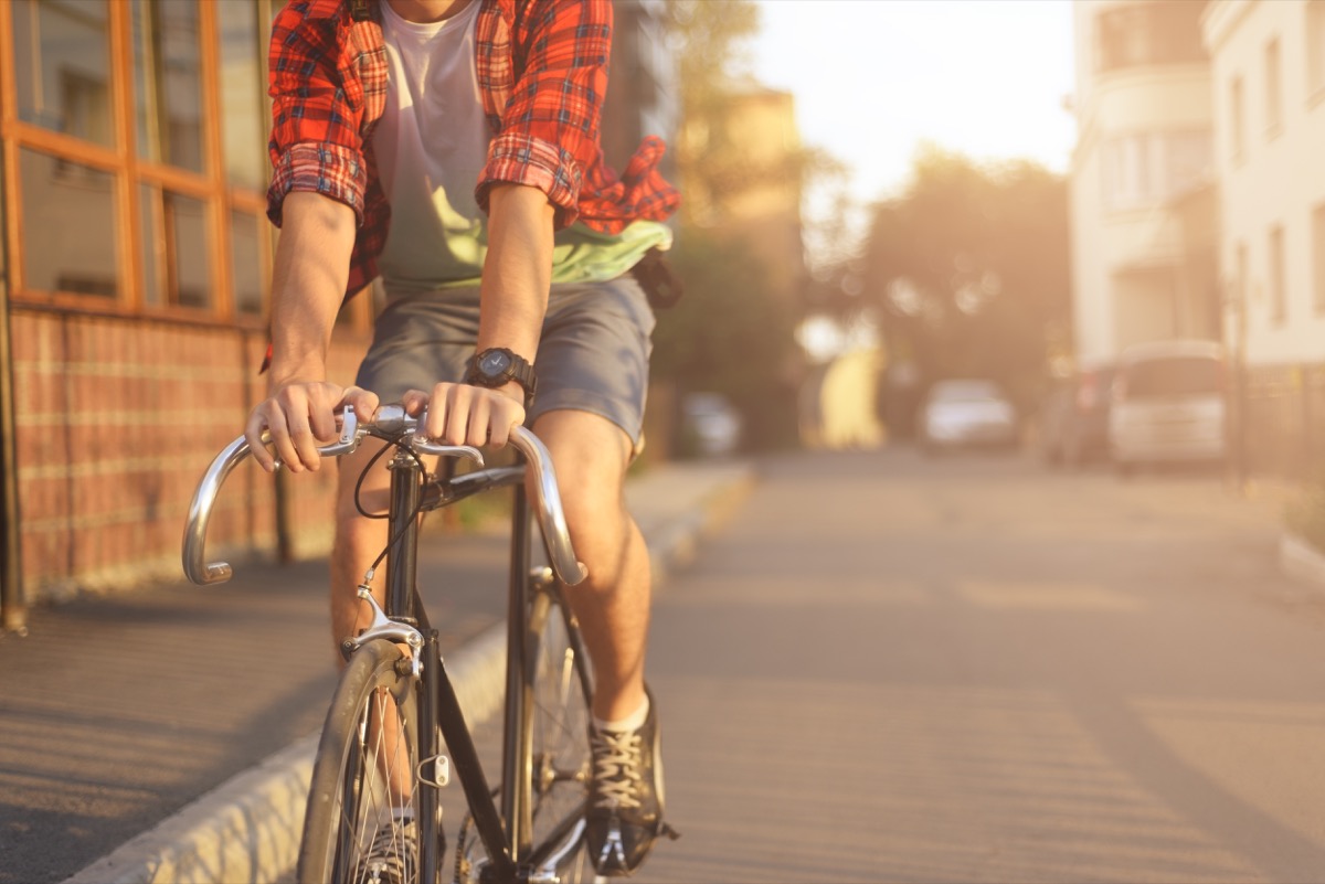 a hipster man wearing flannel and biking