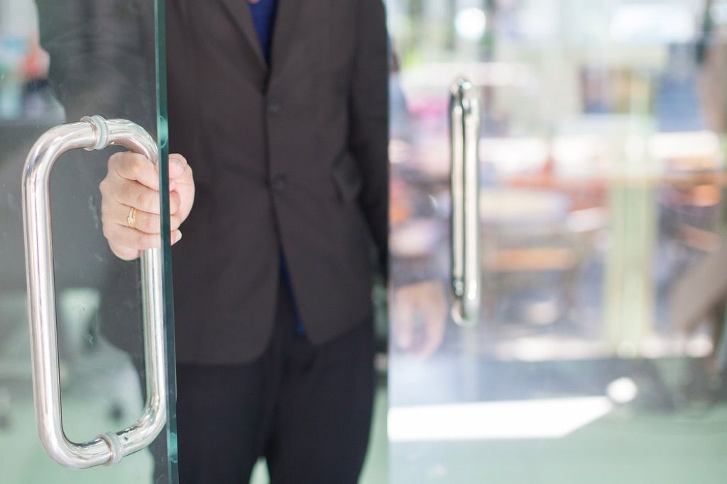 man holding door open, office etiquette