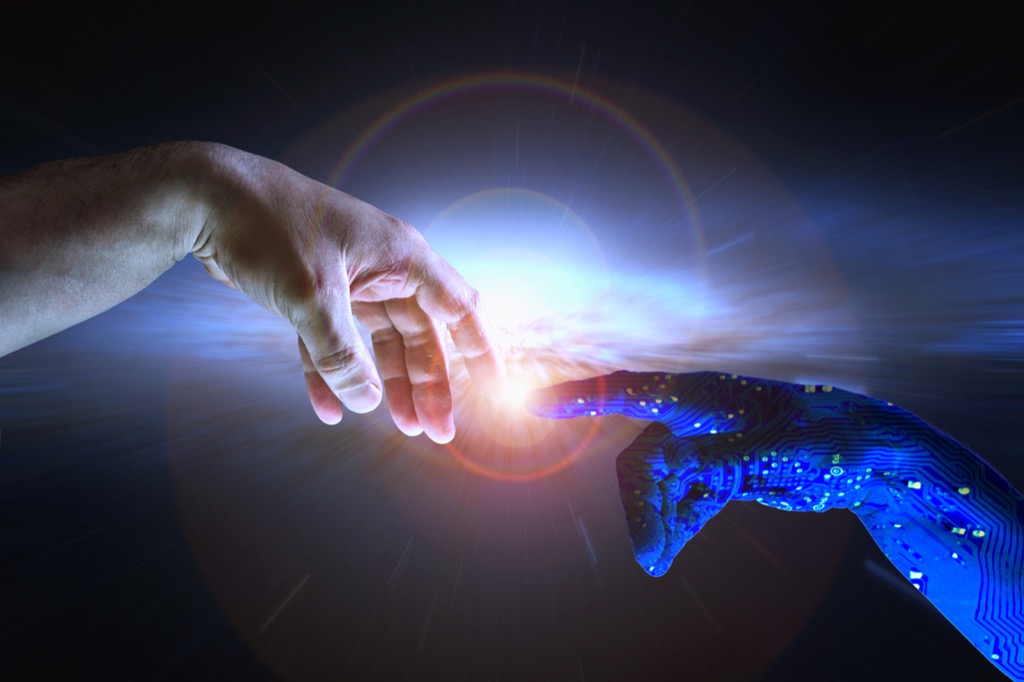 a human hand touching a robot hand