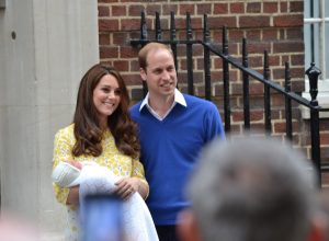 kate middleton and prince william holding a baby