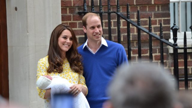 kate middleton and prince william holding a baby