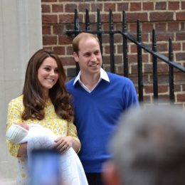 kate middleton and prince william holding a baby