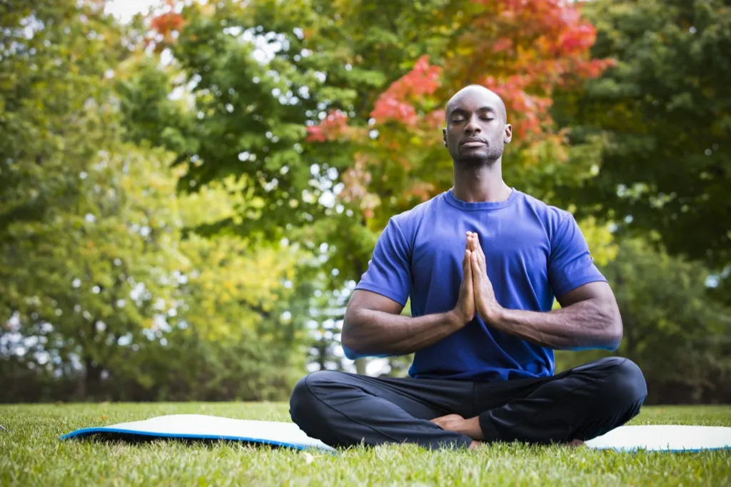 Man Meditating in the Park how people are healthier