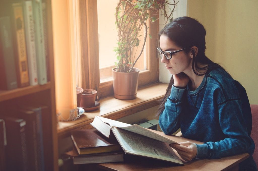 female student looking at textbook