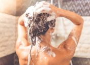 woman shampooing hair in shower