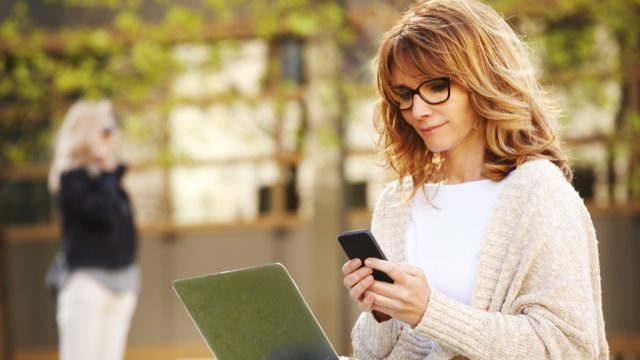 woman working on smartphone and laptop computer, annoying things people do