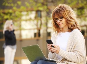 woman working on smartphone and laptop computer, annoying things people do