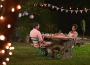 young black couple having dinner outside in garden