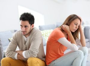 Couple arguing on the couch, things you should never say to your spouse