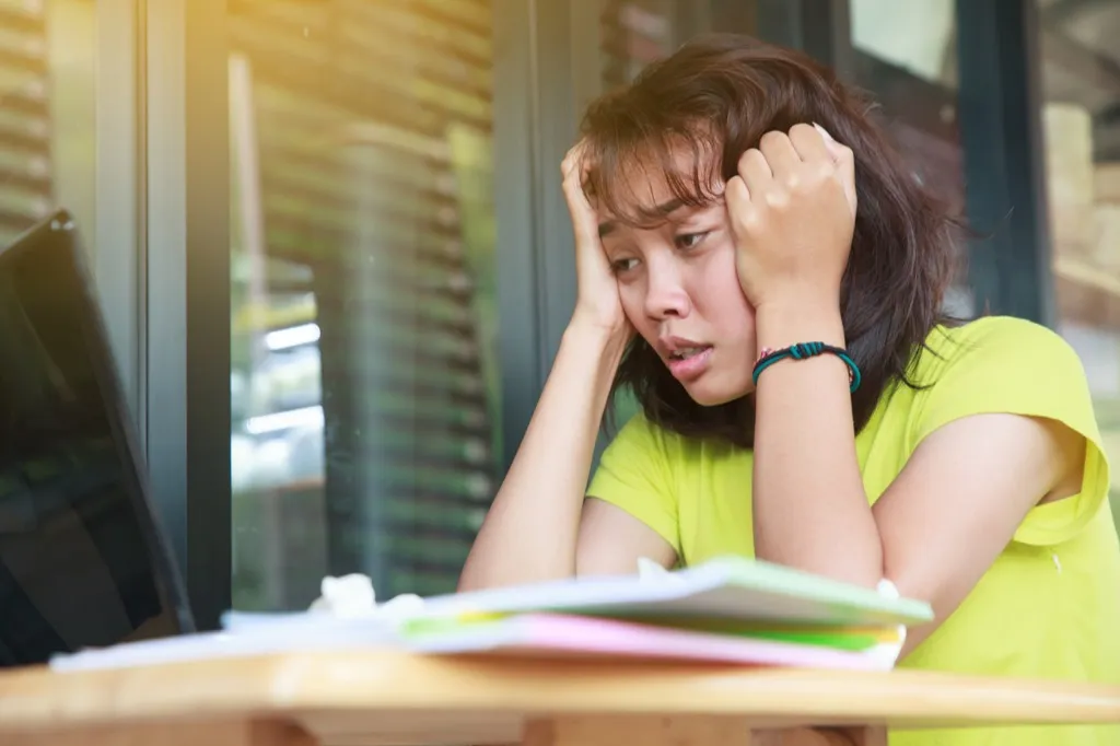 Young stressed woman studying