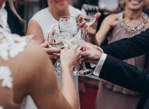 friends clinking glasses using cool words at a sophisticated cocktail party