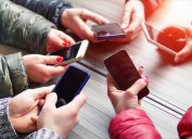 Teens are all sitting in a circle on their phones, addicted to social media