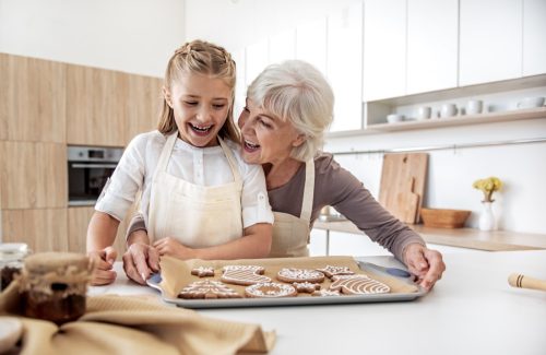 Grandma baking cookies with granddaughter