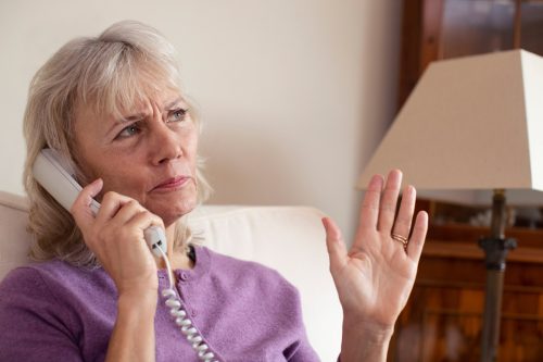 Elderly woman receiving unnecessary calls at home