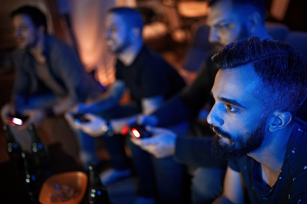 Group of friends playing video game at night
