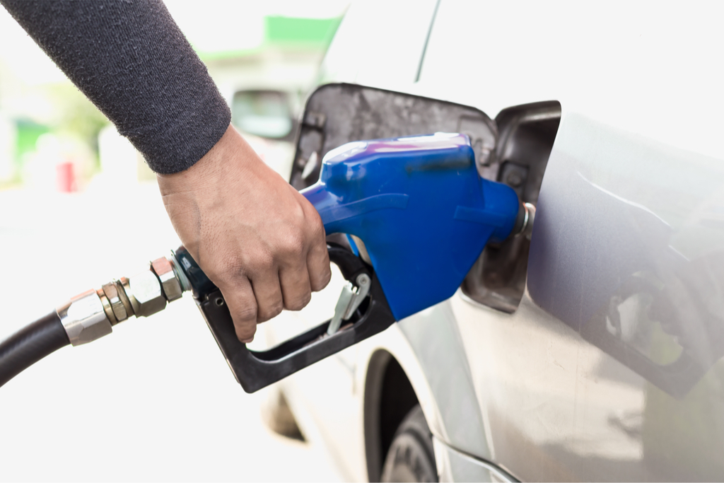 man filling car with gas