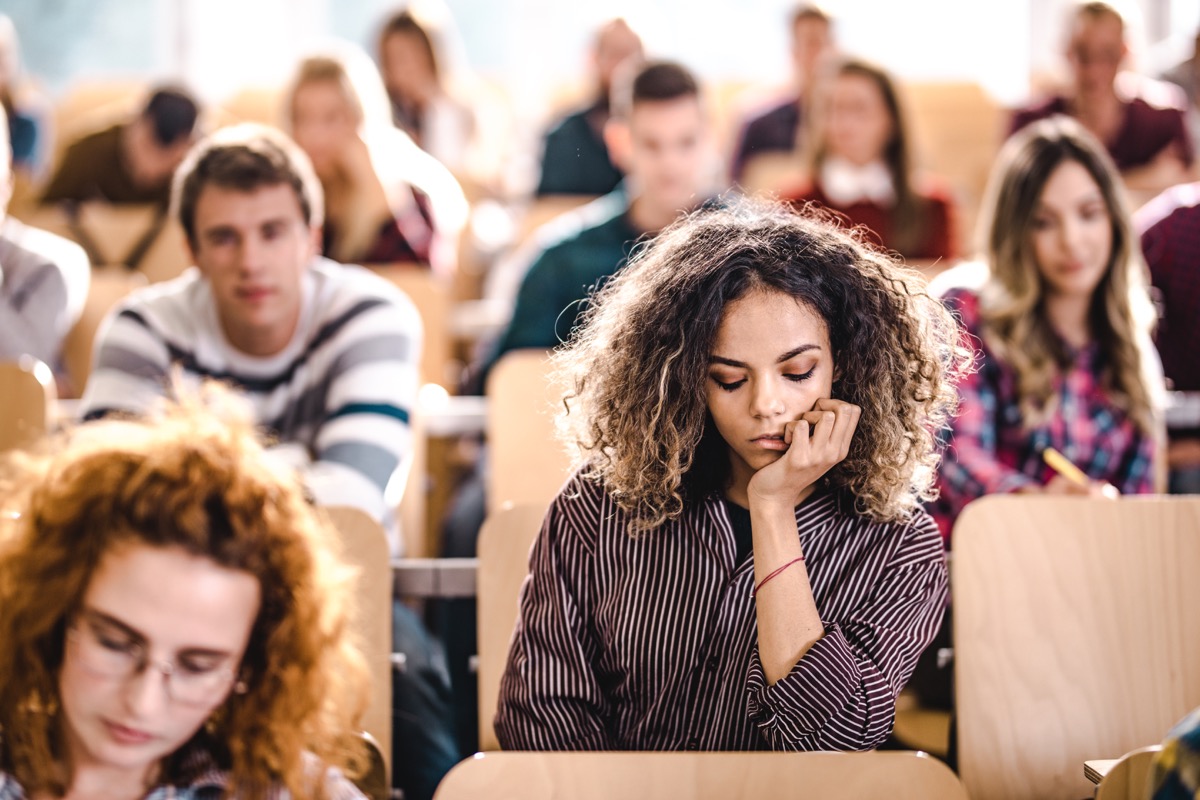female college student looking sad in a college lecture